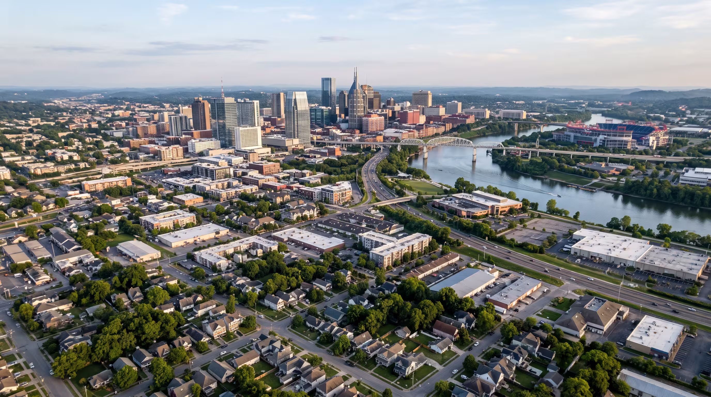 Aerial view of the Nashville skyline, waterfront, and surrounding neighborhoods in Tennessee.