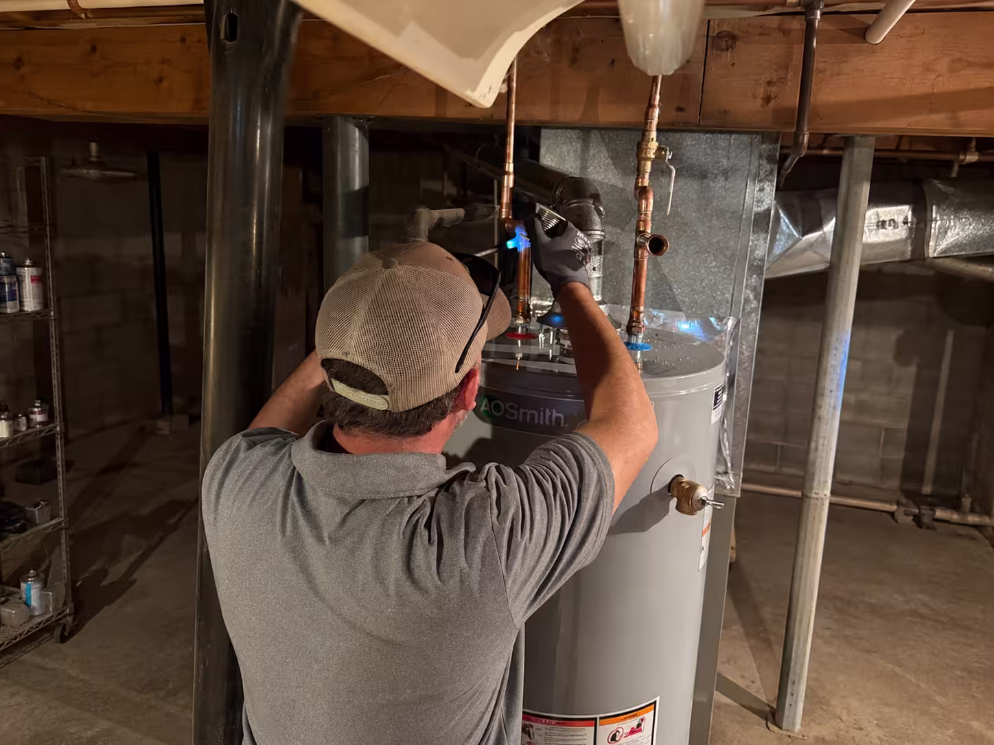 Technician servicing a residential water heater